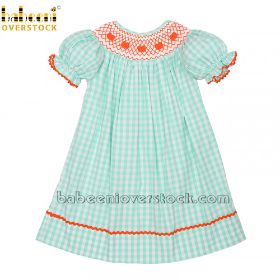 Smocked dress with embroidered pumpkin and geometric pattern