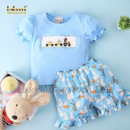 Girl set with smocked colorful Easter rabbit and eggs
